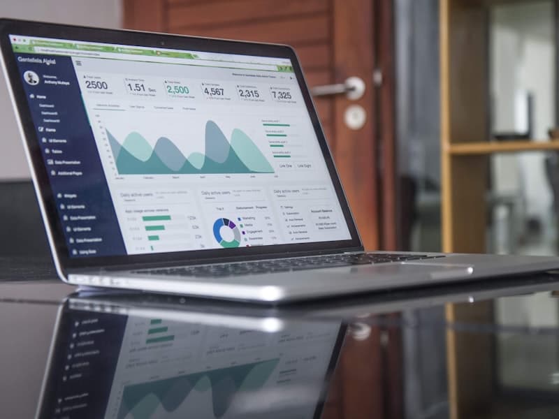 Laptop displaying analytics dashboard with charts and data insights